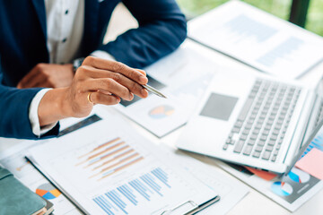 Business man is checking and auditing the business performance with a help from his college....