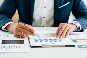 Business man is checking and auditing the business performance with a help from his college....