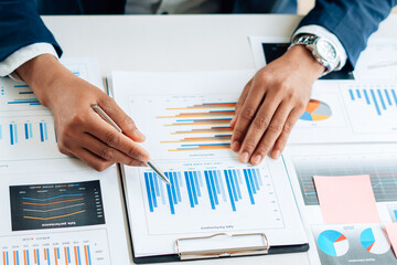Business man is checking and auditing the business performance with a help from his college....
