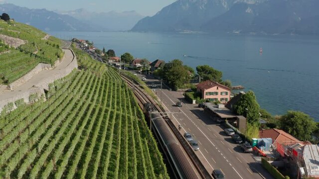 Low aerial of train driving through beautiful Swiss countryside