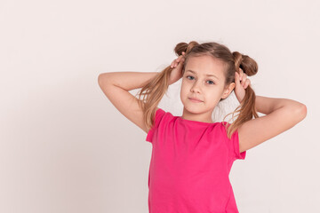 happy child on a white background. a girl in a pink T-shirt and pants.