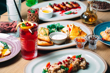 Various breakfast dishes are served on the table in the restaurant.