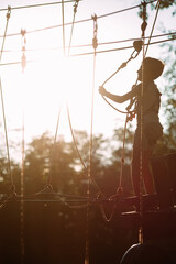rope park. A boy passes an obstacle on tires in a rope Park.
