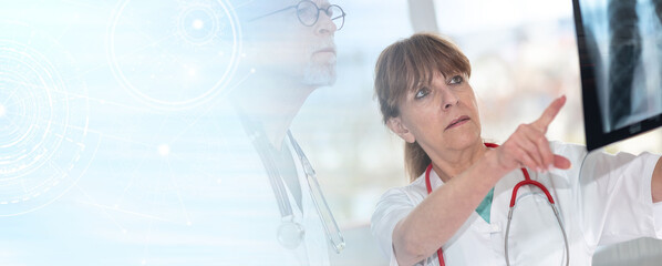 Two doctors examining x-ray report; panoramic banner