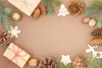 Obraz na płótnie Canvas Christmas background with gift boxes, cones, branches of Christmas tree, Christmas ornaments on brown surface