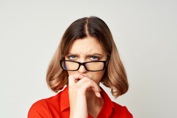 cheerful business woman in a red shirt wearing glasses manager work