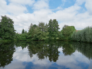 Fototapeta na wymiar Pond with trees on the edge