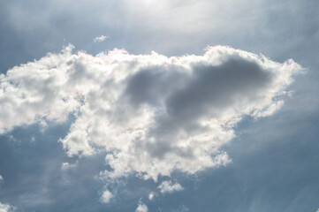 Sun came out from behind clouds.bright sun against blue sky with white-gray cloudy clouds,