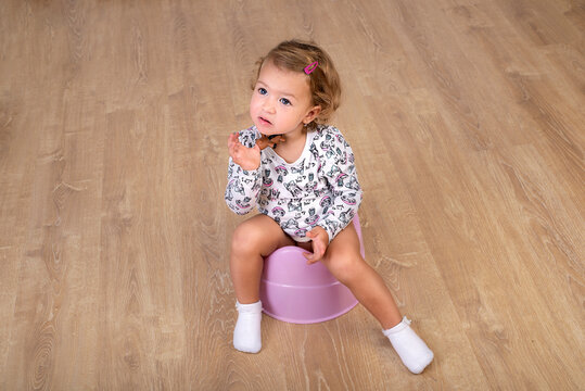 Little girl 2 years  learns to sit on a chamber-pot. Diaper weaning