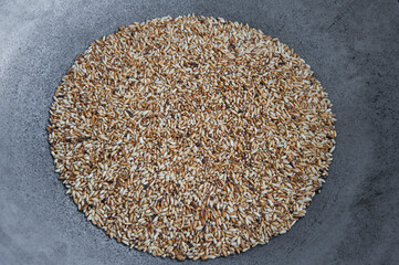 Ground roasted rice in the pan.