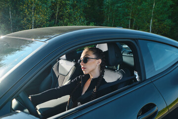 Serious woman driving powerful car