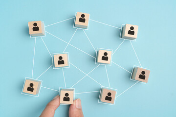 building a good team , Wooden blocks with people icon on blue background, Human resources and management concept.