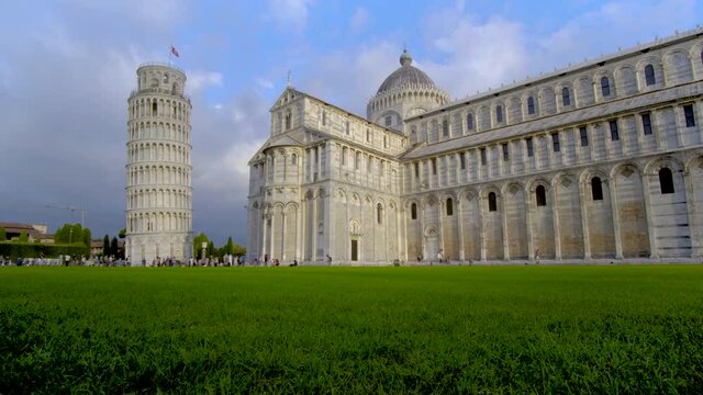 Beautiful spring view of famous Leaning Tower in Pisa. Sunny morning scene with hundreds of tourists in Piazza dei Miracoli.