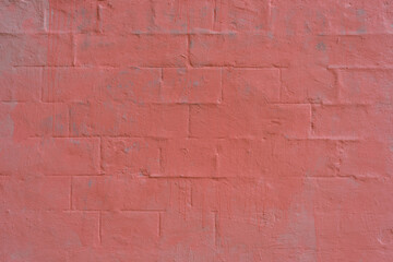 Brick wall painted bright pink. Brick wall with drips of paint. Textured wall.