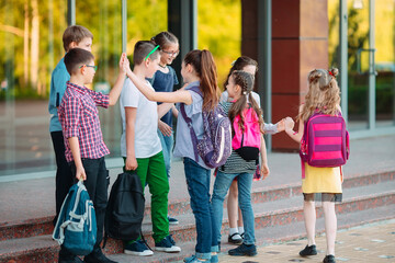 Schoolmates go to school. Students greet each other.