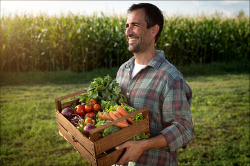 Authentic shot of happy smiling male farmer walking with basket with fresh harvested at the moment...