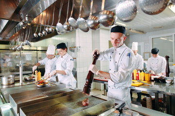 Modern kitchen. The chefs prepare meals in the restaurant's kitchen.