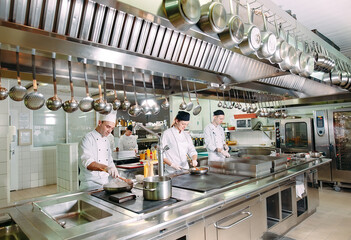 Modern kitchen. The chefs prepare meals in the restaurant's kitchen.
