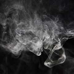 clouds of white smoke on a black background
