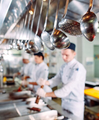 Modern kitchen. The chefs prepare meals in the restaurant's kitchen.