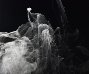 clouds of white smoke on a black background