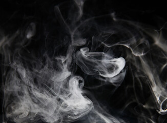 clouds of white smoke on a black background