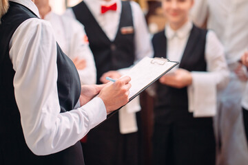 restaurant manager and his staff in kitchen. interacting to head chef in commercial kitchen.