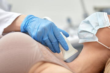 woman getting ultrasound of a thyroid from doctor