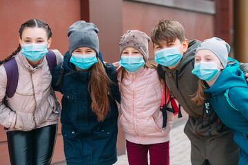 School-age children in medical masks. portrait of school children.