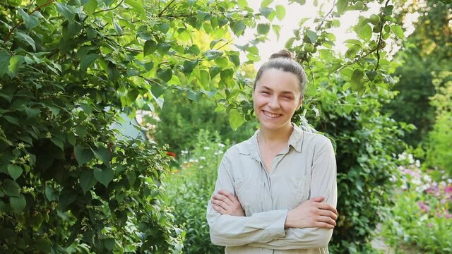 Young woman smiling outdoor. Beautiful brunete girl resting on park or garden green background. Free happy woman at summertime. Freedom happiness carefree happy people concept