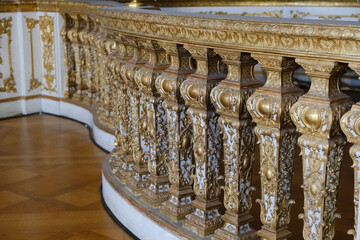 Elegant, oppulent and antique furniture with wood inlays and gold plated ornaments details inside...