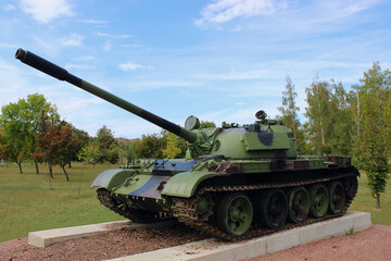 Military tank with camouflage paint in the middle of the forest