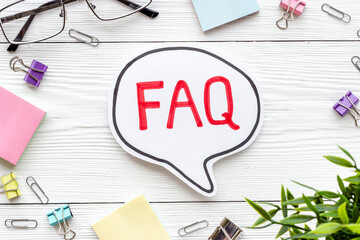 Word faq frequently asked questions with stationery on working place