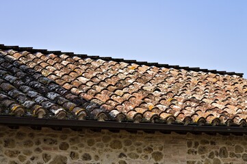The roof with brick tiles of a farm in the Italian countryside (Umbria, Italy, Europe)