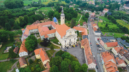 Fototapeta na wymiar Aerial view from drone to romantic citiscape in Poland, Central Europe. HDR warm filtered photography. Church in the middle.