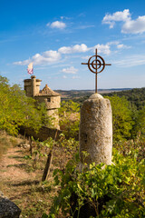 detalle cruz  en monticulo con doble torre medieval con muralla de piedra en medio del monte y...