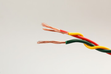 Obraz na płótnie Canvas Three twisted electrical wires on light background, closeup
