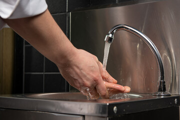  Close up photo of Men washing  hands with water.. No face