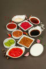 Set of different sauces - ketchup, mayonnaise, barbecue, soy, chutney, wasabi, adjika, horseradish