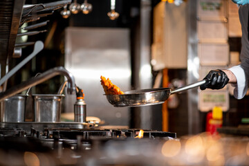 Cropped view of chef cooking Italian pasta with cheese, vegetable