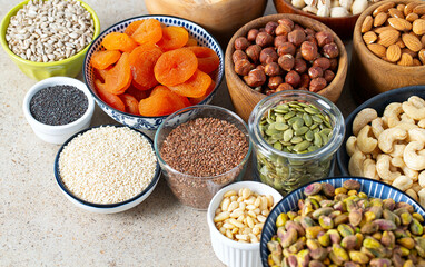 fresh nuts and dried fruis on granite surface