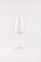 Empty transparent wine glass on the white background
