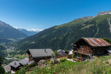 Fototapeta na wymiar Village of Bellwald with the mountains Weisshorngruppe and Eggishorn in background