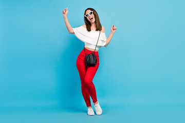 Photo of pretty adorable young lady wear off-shoulders shirt dark eyewear smiling dancing isolated blue color background