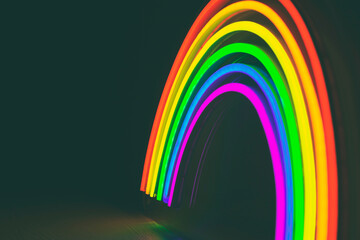 led neon rainbow laying on the white table