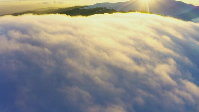 Wonderful view of extraordinary cloudy valley and bright orange sunset