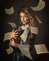 Portrait of a beautiful woman holding a book and flying pages with classic, victorian style outfit...