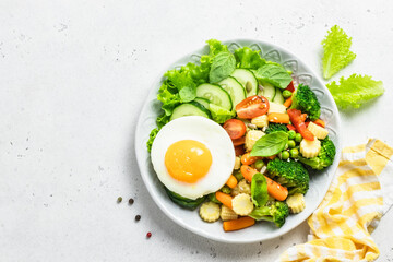 Light low calorie keto lunch egg vegetables bowl. Top view, space for text.