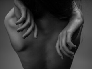 back of a woman naked body posing black and white photo