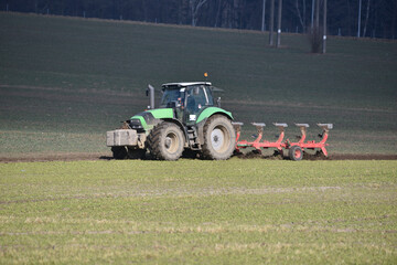 tractor prepares a field for sowing